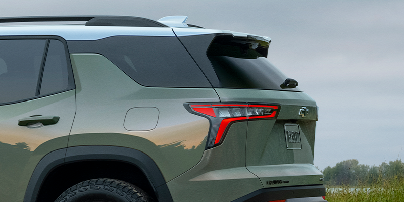 A 2025 Chevrolet Equinox parked on a scenic road, showcasing its sleek design and modern features.