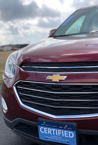 Front view of a maroon Chevrolet SUV showcasing its sleek design and distinctive grille.